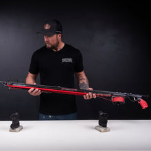Load image into Gallery viewer, Man holding Aimrite vendetta roller speargun with white desk and black background
