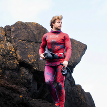 Load image into Gallery viewer, red/purple 3mm wetsuit for spearfishing, rock background