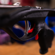 Load image into Gallery viewer, close up view of aimrite handle with silver mechanism, red safety and shaft