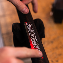 Load image into Gallery viewer, Close up view of person placing rollergun sticker on aimrite speargun barrel