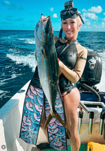 Load image into Gallery viewer, Woman holding a fish and Aimrite Mermaid scale fins on a boat in the ocean