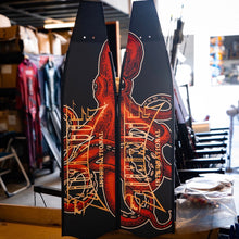 Load image into Gallery viewer, aimrite Freediving and spearfishing fins,  (orange octopus) full view with workshop background
