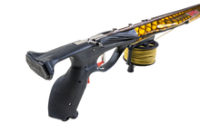 Load image into Gallery viewer, Aimrite vengeance roller speargun close up back/side angle view of handle with black grips and gold dragon scale hydro dipped barrel
