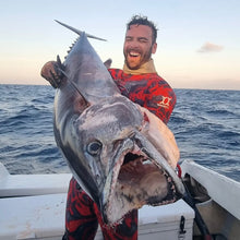 Load image into Gallery viewer, Man holding a large fish on a boat with ocean in the background, lifestyle photo

