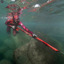 Load image into Gallery viewer, Person diving in clear water with a speargun
