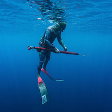 Load image into Gallery viewer, Person spearfishing underwater in clear blue water
