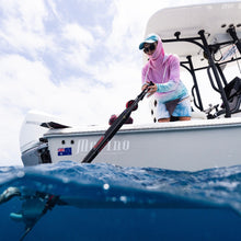 Load image into Gallery viewer, Person on a boat with a fishing rod, water and sky visible
