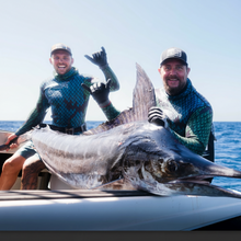 Load image into Gallery viewer, Two divers with a stripped marlin sitting at the back of the boat
