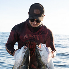 Load image into Gallery viewer, Diver wearing aimrite black trucker hat holding kingfish
