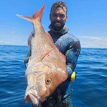 Load image into Gallery viewer, Man holding a large fish on a boat with blue water and sky in the background

